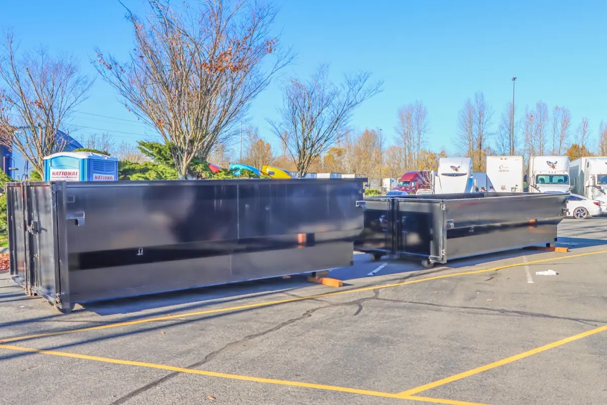 Professional dumpster rental service with roll-off container on residential driveway in Stone Ridge